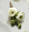 The FTD White Ranunculus Boutonniere