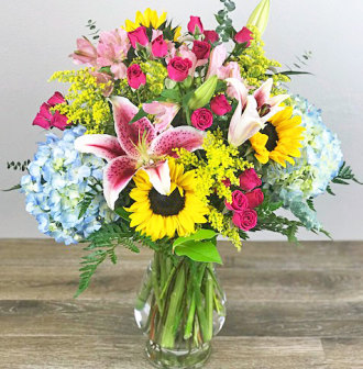 Large Vase Featuring Sunflowers and Lilies