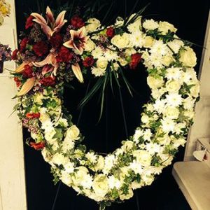 Sympathy Wreath of white roses with stargazer lilies