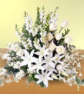White lily sympathy spray and other sympathy gift ideas for delivery to Reyers, Heritage Life Story, Cook and Pederson funeral homes by Sunnyslope Floral