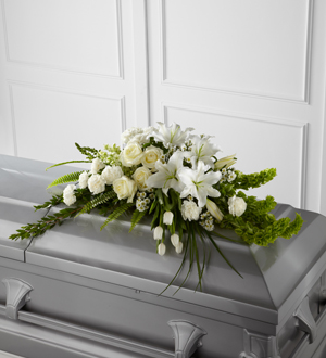 Order & send white lily & other flower casket sprays from the family to funeral homes in the Grand Rapids Mi area & world wide with Sunnyslope Floral